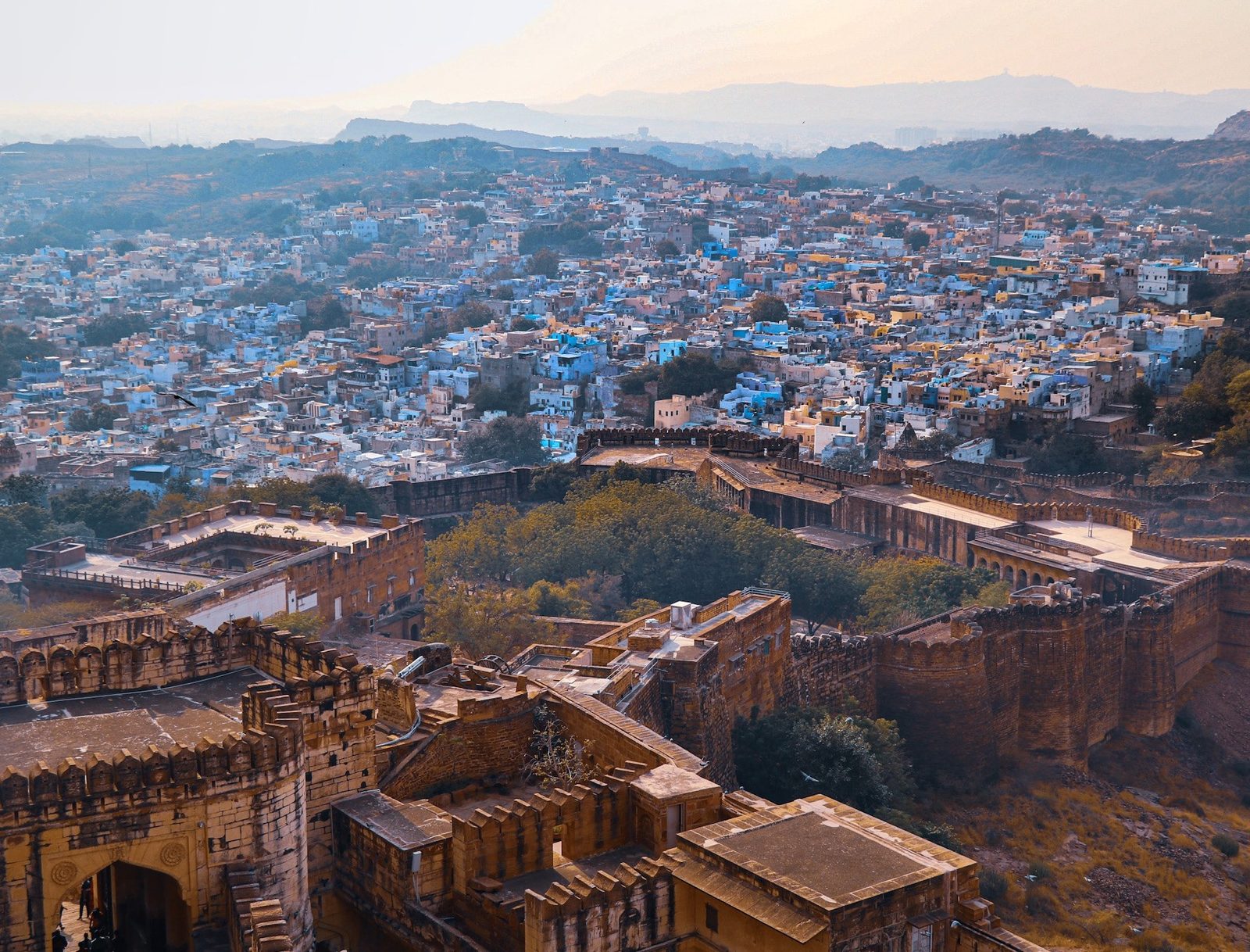Opening frame of THE BLUE CITY — city / rooftops / ramparts.